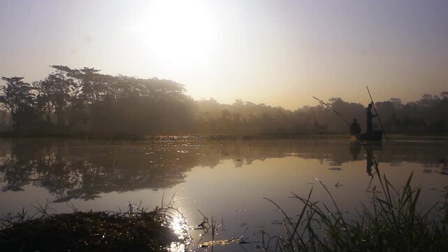 Forest Silhouettes Reflected On Idyllic River With Sailing Person During Sunset. Aerial Shot. A man in the middle of the lake boat during morning fishing 