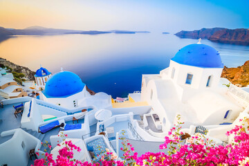 traditional greek village Oia of Santorini, with blue domes of churches and village roofs, Greece