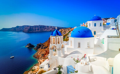 traditional greek village Oia of Santorini, with blue domes against sea and caldera, Greece © neirfy