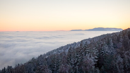 Winter sunrise over snowy Jura mountains in Switzerland