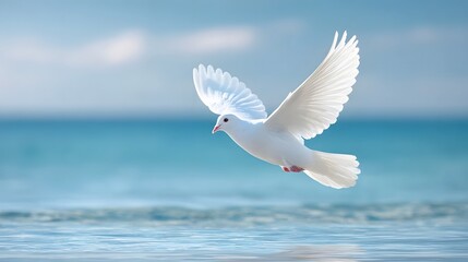 Serene flight of a pure white dove over the calm ocean wings spread against a soft blue sky with clouds conveying a message of peace and freedom