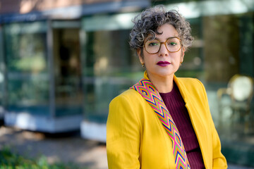 Confident businesswoman in vibrant yellow jacket