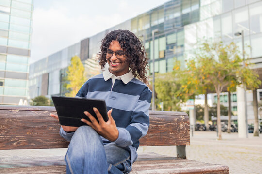 Non-binary person enjoying digital content in city setting
