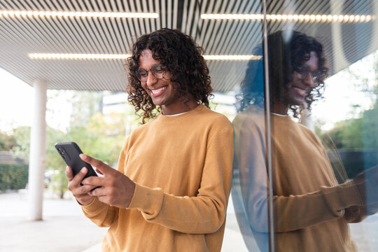 Non-binary person enjoying urban lifestyle with smartphone