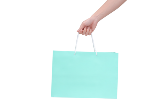 Hand holding green shopping bag with empty space on transparent background