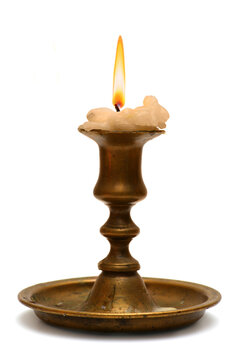 burning old candle vintage bronze Silver candlestick. Isolated On White Background.