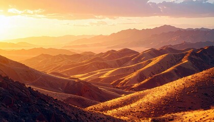 Naklejka premium Rolling desert mountains illuminated by the warm glow of a setting sun, creating dramatic shadows and highlighting the arid landscape.