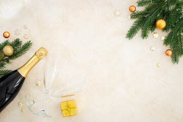 Christmas fir tree branch with champagne bottle and decoration, top view. Happy New Year greeting card