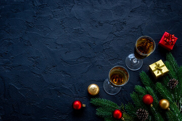 Christmas decoration top view - fir tree branch and two glasses of champagne. Festive flat table setting