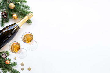 Christmas decoration flat lay with champagne bottle and two glasses, top view