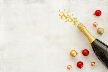 Christmas decoration flat lay with champagne bottle and two glasses, top view