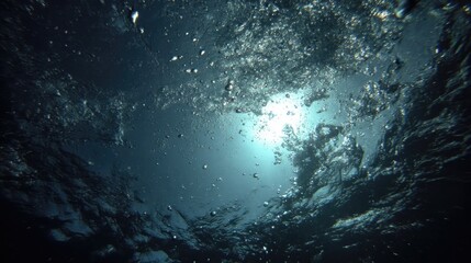 Underwater Perspective Looking Up Toward the Surface with Sunlight and Bubbles