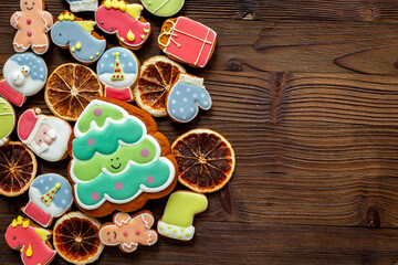 Set of different Christmas and New Year gingerbread cookies on dark wooden background, top view. Festive food concept