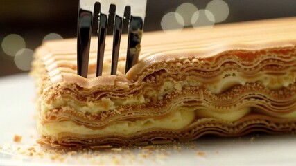 Layers of sweet pastry and cream create a delightful dessert perfect for any celebration or festive occasion.