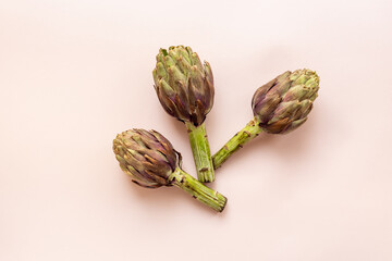 Top view of tree whole heads of purple artichokes. Vegetable ready to cook