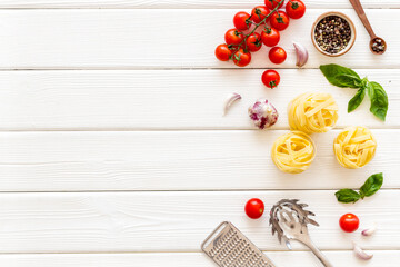Food ingredients for cooking Italian pasta with tomatoes and basil leaves, top view