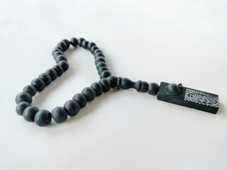 black wooden prayer beads on white background
