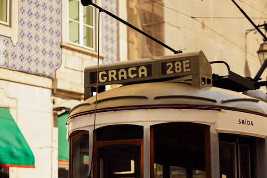Iconic Lisbon tram with azulejo background