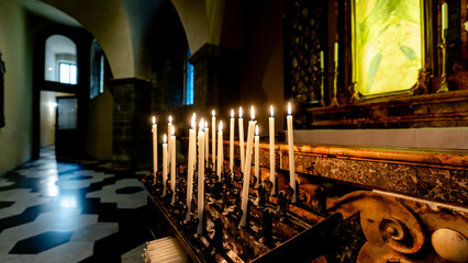 Candlelit altar in historic Como church interior
