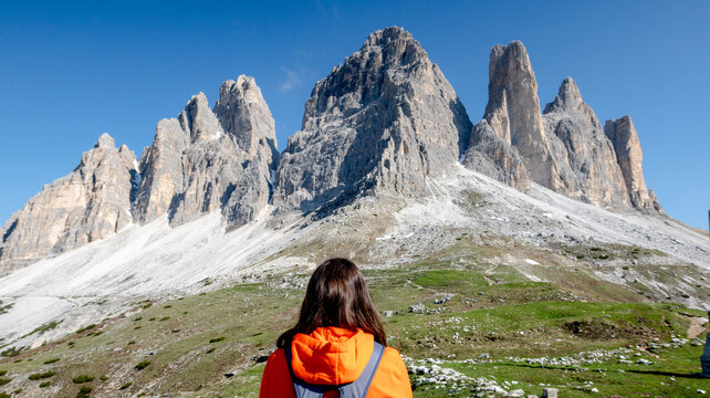 Woman gazing at majestic Tre Cime di Lavaredo in Dolomiti