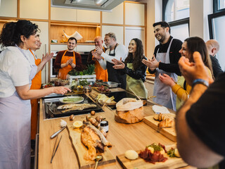 Friends enjoy cooking class and teambuilding event in kitchen