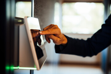 Hand touching touchscreen sensor for access control in modern office