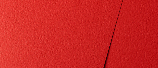 Textured bright red paper with a fine embossed surface and a clean diagonal edge creating a vivid