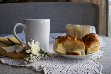 A special breakfast for a romantic Valentine's Day. Candles, pastries and white flowers for a day of love and celebration.