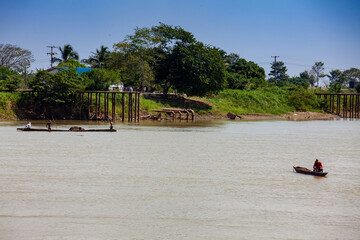 People at traditional wooden canoes at the Sinu River in Lorica, Colombia