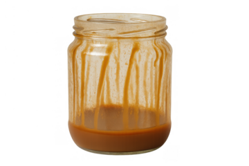 Glass jar with caramel residue and sauce at the bottom, sticky sweet dessert leftovers on transparent background