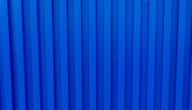 Blue technology background,Modern blue building wall backdrop,Background with texture of metal cladding.Blue stripes of modern architecture, Blue mono tone of metal panels for cladding the exterior.