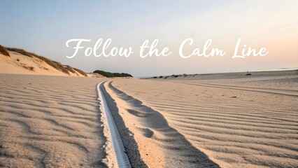 A sand dune path with motivational text during daylight