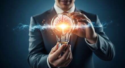 Creative man holding a light bulb with brain inside idea concept