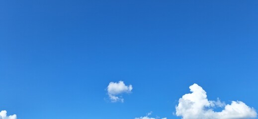 Sunny Blue Sky Background: Fluffy White Cumulus Clouds on a Clear Day