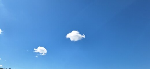 Sunny Blue Sky Background: Fluffy White Cumulus Clouds on a Clear Day