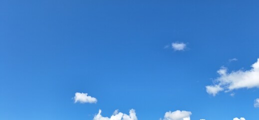 Sunny Blue Sky Background: Fluffy White Cumulus Clouds on a Clear Day