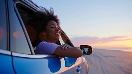 A joyful woman enjoying a scenic 4K video sunset drive along a beach