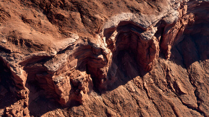 Obraz premium Red Rock Formations: A close-up shot captures the raw beauty of layered, weathered red rock formations. The textures, colors, and shadows evoke a sense of the earth's timeless artistry.