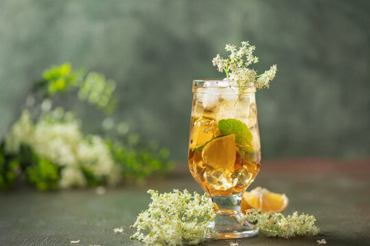 Hugo spritz cocktail  with wine, elderflower syrup, lemon, mint and ice in glass on the table
