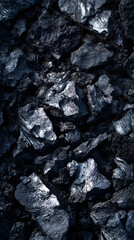 Fototapeta premium Dark Coal Texture: A detailed close-up reveals a rugged texture of dark coal, showcasing its natural patterns and inherent beauty.
