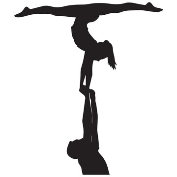 Silhouetted acrobats perform a dynamic and balanced human pyramid pose
