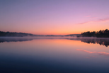 Obraz premium sunrise reflecting on a still lake surface with pastel colors creating a peaceful gentle morning calmness