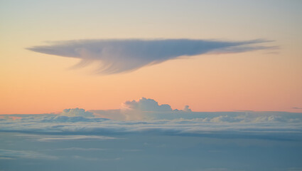 Surreal skyscape a lenticular cloud resembles a spaceship hovering above a sea of cumulus clouds at sunset