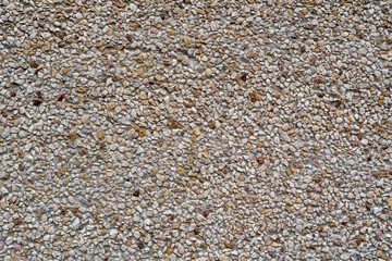 Textured surface made of small stones creates a natural aesthetic for outdoor spaces in bright daylight