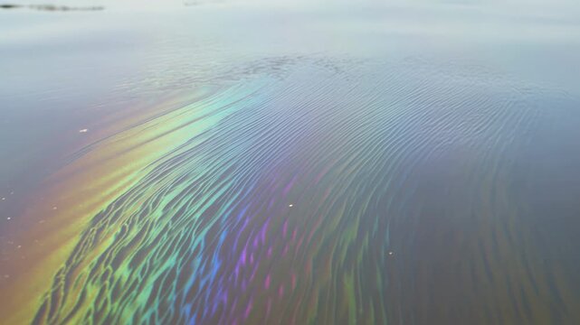 Vibrant colors and fluid patterns emerge in the water, showcasing a beautiful blend of shapes and hues. The scene captures the enchanting motion of nature's art over time