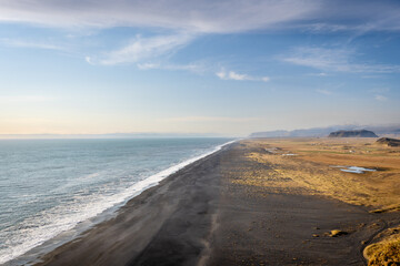 Perched above roaring waves and endless black sands, Dyrhólaey reveals Iceland’s raw beauty.