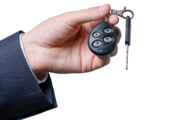 Hand holding a car remote key fob with a key on a transparent background