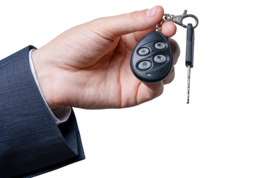 Hand holding a car remote key fob with a key on a transparent background