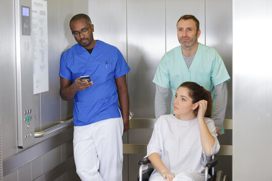 patient doctor and porter in a hospital elevator