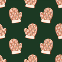 Seamless pattern with gingerbread cookie in form of glove decorated of sugar icing on a dark green background. Vector festive background.